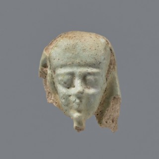 Fragment of a shabti. Head of a shabti figurine with carefully rendered facial features; smooth wig