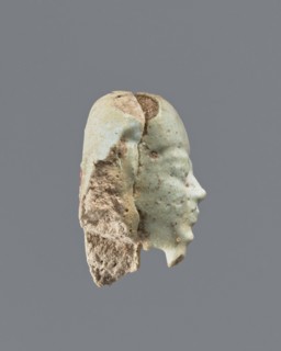 Fragment of a shabti. Head of a shabti figurine with carefully rendered facial features; smooth wig