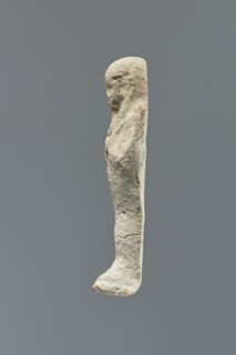 Ushabti, Mummy-shaped figurine standing on a base, flat back. Arms crossed on the chest, right