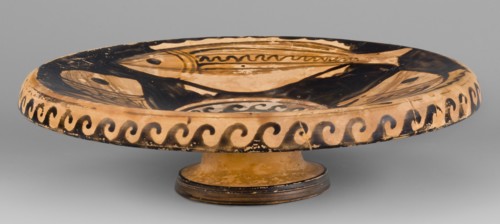 Red-figure plate depicting fish; plate with an inwardly curled edge. Interior painted with four