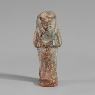 Ushabti, mummy-shaped figurine. Made of clay, painted cream with black details. Arms crossed on the