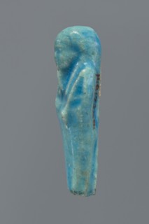 Shabti, mummy-shaped figurine, funerary gift; back supported by a pillar/pilaster. Legs missing up