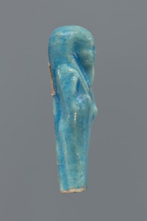 Shabti, Mummy-shaped figurine, back supported by a pillar/pilaster. Legs missing up to knee height.