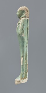 Shabti, mummy-shaped figurine, funerary gift; standing on a base with back supported by a