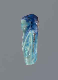 Shabti, mummy-shaped figurine, funerary gift, back supported by a pillar/pilaster. Legs missing.