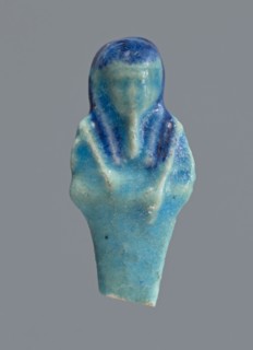 Shabti, Mummy-shaped figurine used as a funerary offering, supported at the back on a pillar. Legs