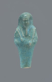 Shabti, Mummy-shaped figurine, funerary gift, supported at the back on a pillar. Legs missing from