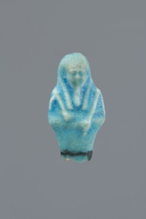 Shabti, Mummy-shaped figurine, funerary gift, supported on a pillar at the back. Legs missing. Arms