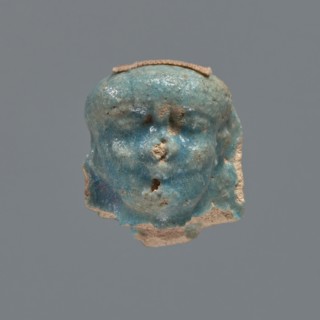 Shabti head, mummy-shaped figurine, funerary gift. Head of a shabti figurine depicting a king: oval