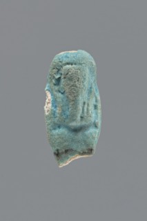 Shabti, Mummy-shaped funerary figurine, legs missing. Arms crossed on the chest, hands invisible