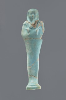 Ushabti, Mummy-shaped figurine, standing on a base with a narrow, slightly convex pillar at the