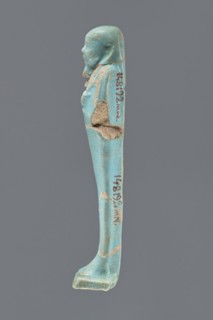 Ushabti, Mummy-shaped figurine, standing on a base with a narrow, slightly convex pillar at the