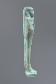 Ushabti, Mummy-shaped figurine, funerary offering, standing on a base with a narrow, slightly