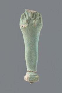 Shabti, mummy-shaped figurine, standing on a base; head missing. Narrow, slightly convex pillar at
