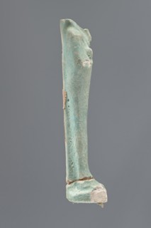 Shabti, Mummy-shaped figurine, standing on a base; head missing. A narrow, slightly convex pillar