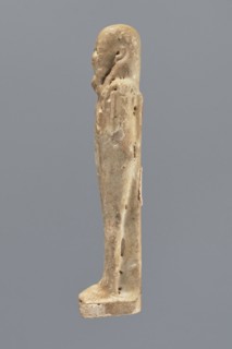 Shabti, Mummy-shaped figurine, standing on a base, back supported by a pillar/pilaster. Arms