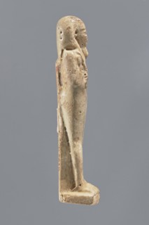Shabti, Mummy-shaped figurine, standing on a base, back supported by a pillar/pilaster. Arms