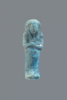 Ushabti, Mummy-shaped figurine impressed in a mold, carelessly made of faience; back flat and