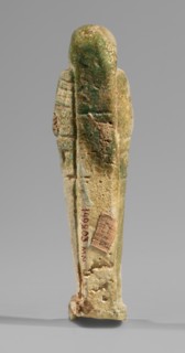 Ushabti, Mummy-shaped funerary figurine, standing on a base and supported at the back by a flat,