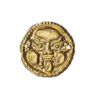 Appliqué in the shape of a Gorgon's head. Decorative appliqué for a tunic made of thin gold plate