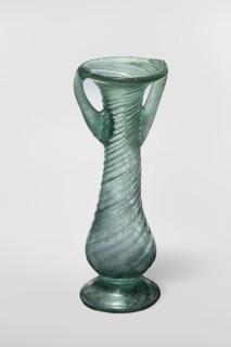 Unguentarium, unknown Eastern workshop. Glass vessel, transparent light green, Barag type VII: 1, 3