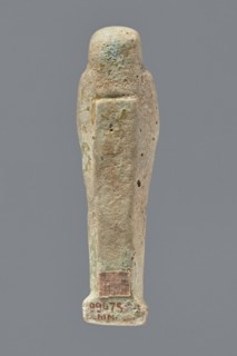 Ushabti, mummy-shaped figurine, funerary gift, hoes. Mummy-shaped figurine standing on a base, the