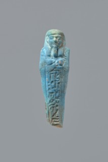 Ushabti, Mummy-shaped figurine, back supported on a flat pillar. Feet missing. Arms crossed on the
