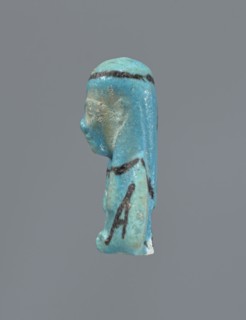 Ushabti, Mummy-shaped figurine, preserved head and fragment of torso. Arms crossed on the chest,