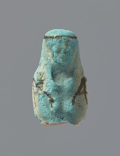Ushabti, mummy-shaped figurine, funerary gift; preserved head and fragment of torso. Arms crossed