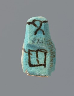 Ushabti, mummy-shaped figurine, preserved head and fragment of torso. Arms crossed on the chest,