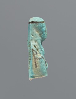 Ushabti, mummy-shaped figurine, preserved head and fragment of torso. Arms crossed on the chest,