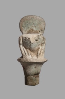 Amulet - falcon head on a column; papyrus capital of the column shows a falcon head in a striped