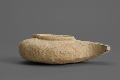 Herodian oil lamp, small clay lamp with a slightly flattened circular container and a fan-shaped