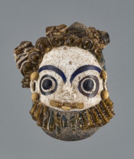 Apotropaic pendant in the shape of a male head; bearded head pendant; Carthage Tunisia; technique