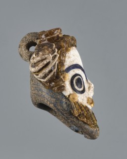 Apotropaic pendant in the shape of a male head; bearded head pendant; Carthage Tunisia; technique
