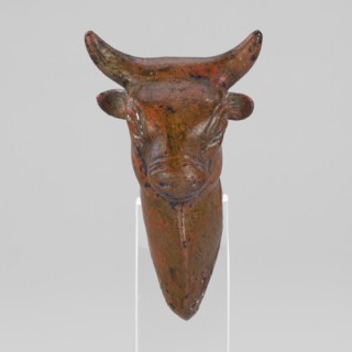 Bull-headed protoma, vessel decoration, unknown Urartian workshop. Stylized bull's head with linear