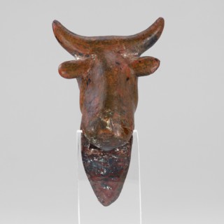 Stylized bull-headed protoma used as vessel decoration, typical Urartian cauldron ornament. Convex