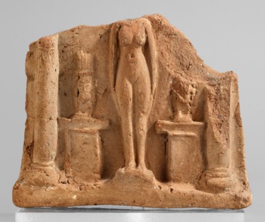 Fragment of a votive plaque in the form of a naos with the fertility goddess Isis-Hathor, and Bes,