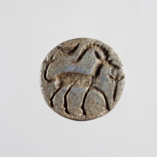 Conical stamp seal with a hole drilled below the top of the cone. On the circular base is engraved