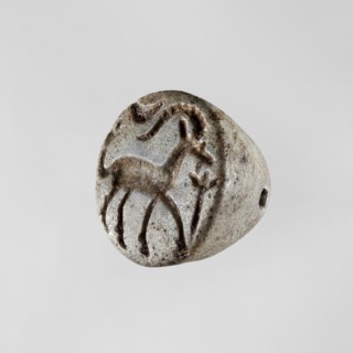 Conical stamp seal with a hole drilled below the top of the cone. On the circular base is engraved