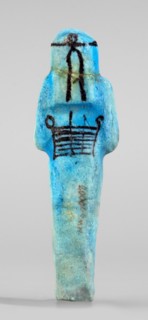Amenhotep's shabti with baskets on the back; arms crossed on the chest, right folded over left,