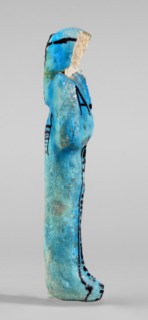 Amenhotep's shabti with baskets on the back. Arms crossed on the chest, the right folded over the