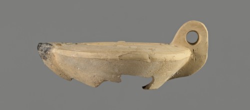 Oil lamp with an image of Helios. Roman single-burner oil lamp made from a mold. Round, flat