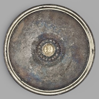 Platter with a gold medallion of Theodosius II. Flat silver platter on a ring-shaped foot with