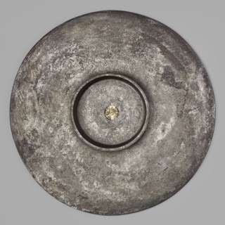 Platter with a gold medallion of Theodosius II. Flat silver platter on a ring-shaped foot with
