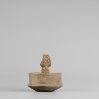 A miniature kyatos with a flat bottom and a bowl whose walls widen diagonally almost halfway up and