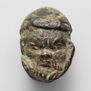 Appliqué in the shape of Silenus's head, The head of a bearded Silenus wearing a cap, designed on