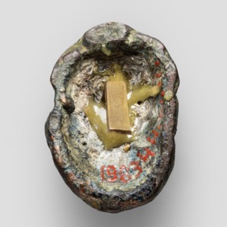 Appliqué in the shape of Silenus's head, The head of a bearded Silenus wearing a cap, designed on