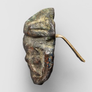 Appliqué in the shape of Silenus's head, The head of a bearded Silenus wearing a round cap with two