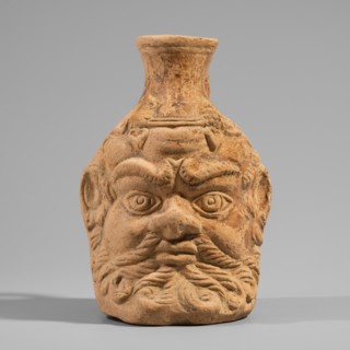 Vessel with a belly in the shape of a satyr's head, unknown Pergamon workshop. A flat-bottomed
